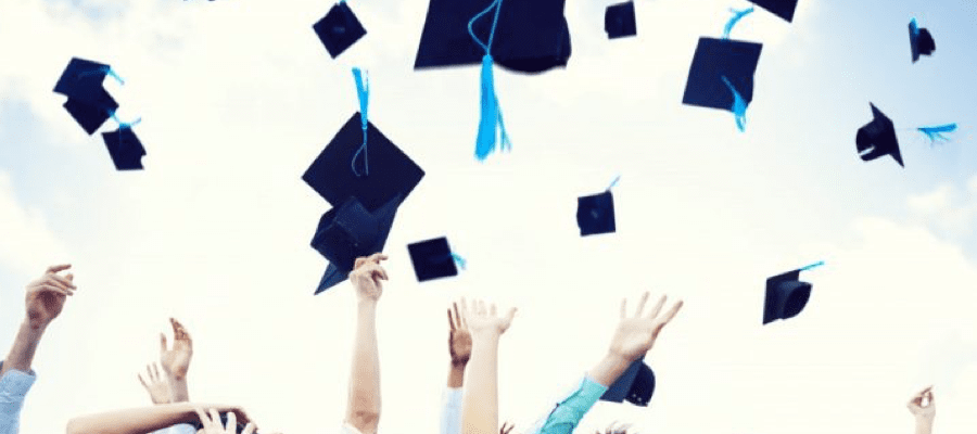 Students throwing their graduation caps in the air